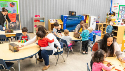 Children in a classroom sitting at tables.